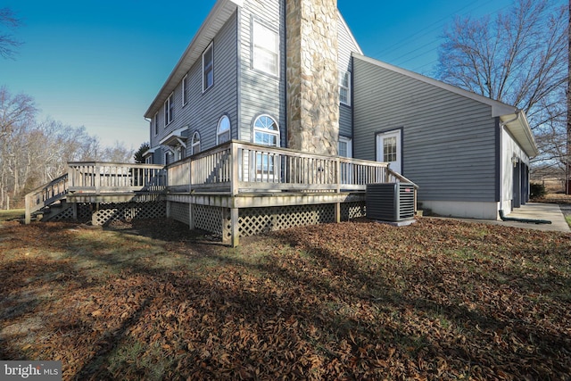 rear view of house featuring a wooden deck