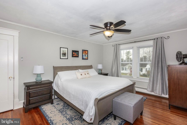 bedroom with a baseboard heating unit, dark hardwood / wood-style flooring, ceiling fan, and crown molding