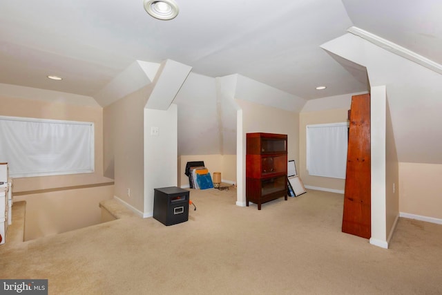 bonus room featuring light colored carpet and vaulted ceiling