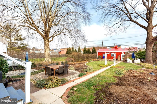 view of yard with an outbuilding and a patio