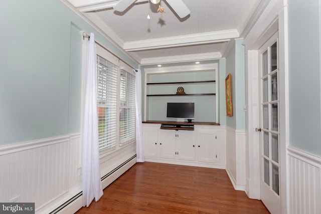 unfurnished living room featuring hardwood / wood-style flooring, built in shelves, ceiling fan, and ornamental molding