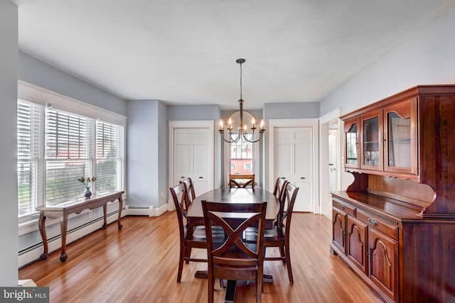 dining room with a chandelier, light hardwood / wood-style floors, and baseboard heating