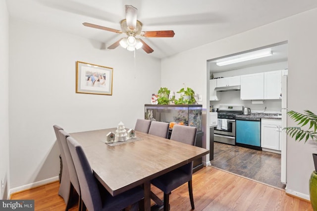 dining area with ceiling fan and light hardwood / wood-style floors