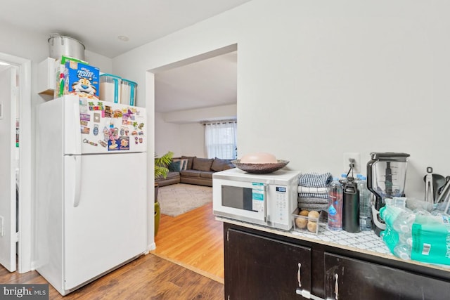 kitchen featuring hardwood / wood-style floors and white appliances