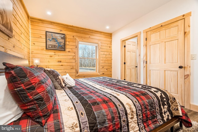 bedroom featuring wooden walls