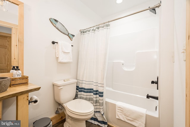 bathroom with shower / bath combination with curtain and toilet