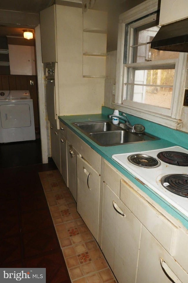 kitchen with ventilation hood, white electric stovetop, sink, and washer / clothes dryer