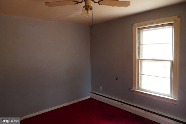 empty room featuring ceiling fan and a baseboard heating unit