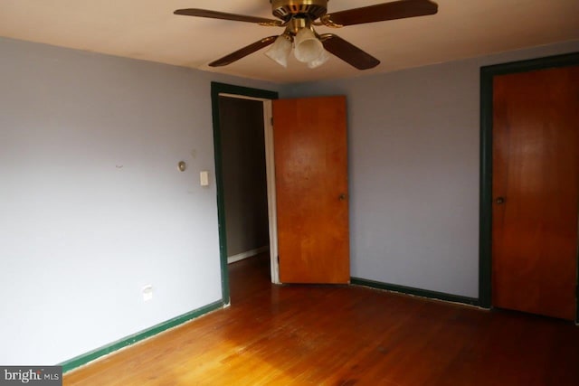 unfurnished bedroom featuring hardwood / wood-style floors and ceiling fan