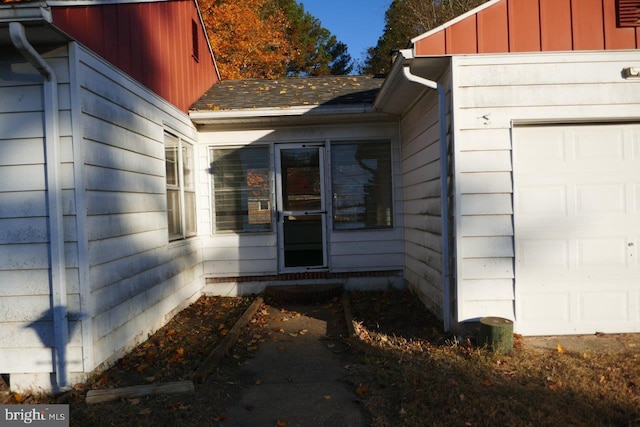 view of exterior entry with a garage