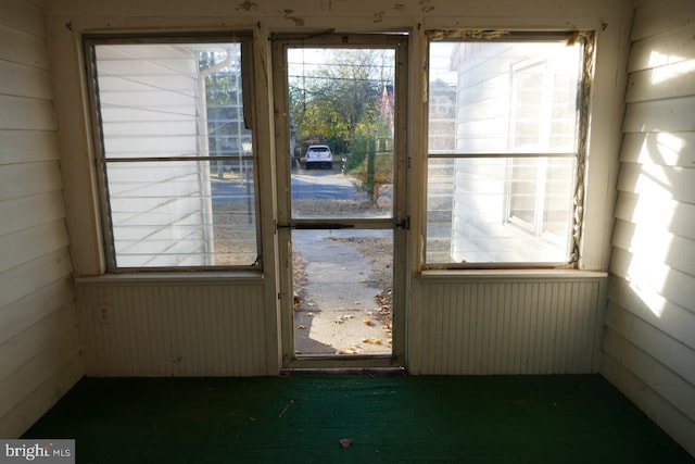 doorway featuring wood walls