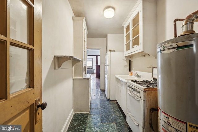 kitchen featuring white cabinets, gas water heater, white appliances, and sink