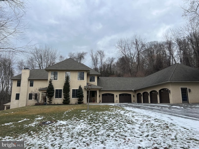 view of front of property with a yard and a garage