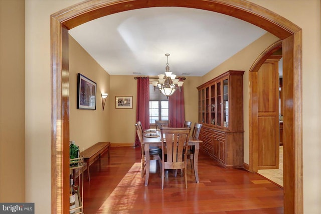 dining space with a chandelier and hardwood / wood-style floors