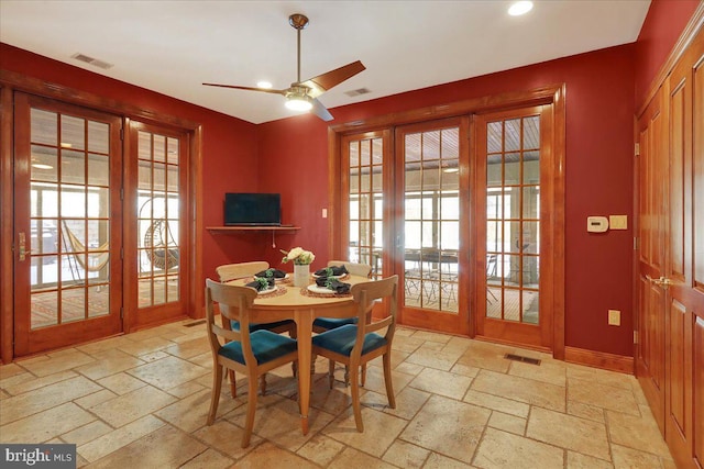 dining space with ceiling fan and french doors