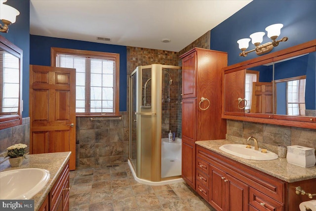 bathroom with tile walls, an enclosed shower, and vanity