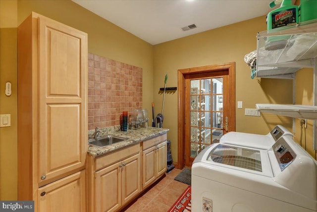 laundry area with washer and dryer, sink, and light tile patterned floors