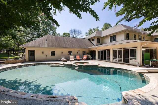 view of pool featuring an in ground hot tub and a patio