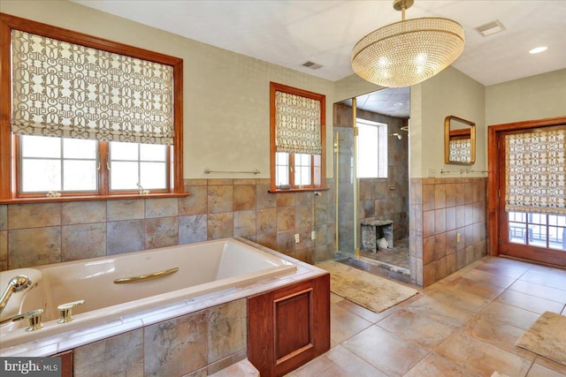 bathroom with independent shower and bath and tile walls