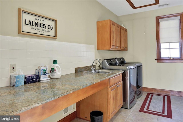 laundry area with washer and dryer, light tile patterned floors, sink, and cabinets