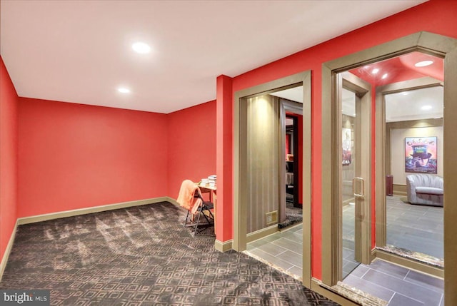 interior space featuring dark colored carpet