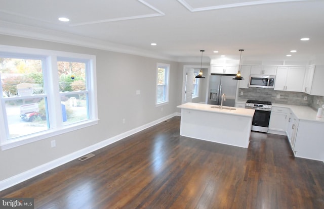 kitchen featuring dark wood-type flooring, a kitchen island, decorative light fixtures, white cabinets, and appliances with stainless steel finishes