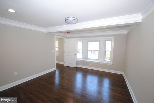 spare room with dark hardwood / wood-style flooring and crown molding