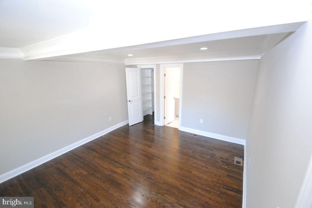 spare room featuring dark hardwood / wood-style flooring and ornamental molding