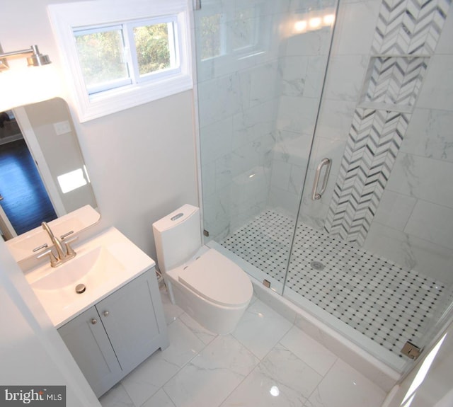 bathroom featuring toilet, vanity, and walk in shower