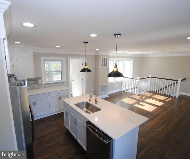 kitchen with a center island with sink, a wealth of natural light, sink, and appliances with stainless steel finishes