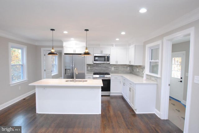 kitchen featuring sink, hanging light fixtures, dark hardwood / wood-style floors, a kitchen island, and stainless steel appliances