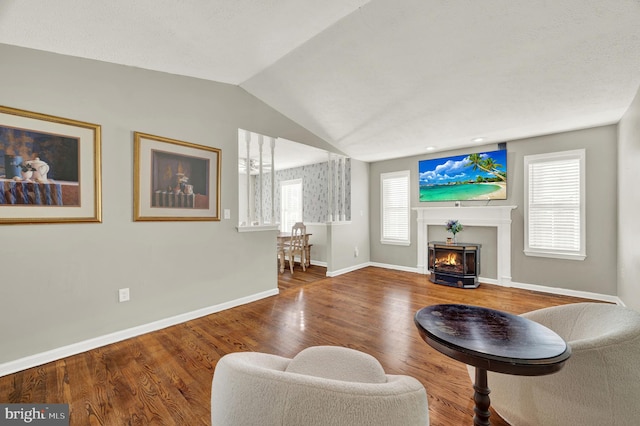 living room featuring wood-type flooring and vaulted ceiling