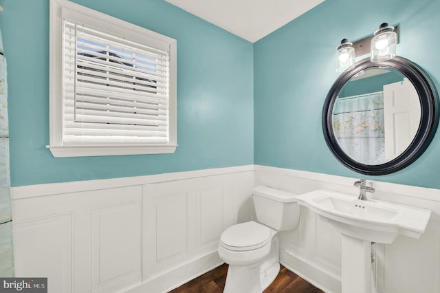 bathroom featuring hardwood / wood-style flooring and toilet