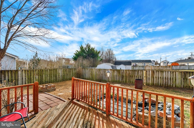 wooden terrace featuring an outdoor fire pit