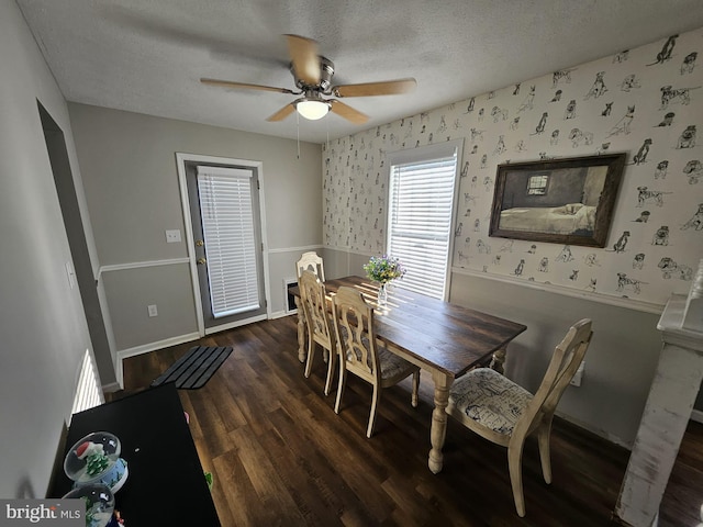 dining area with a textured ceiling, ceiling fan, and dark wood-type flooring