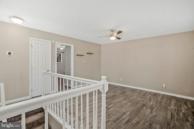 corridor with hardwood / wood-style flooring