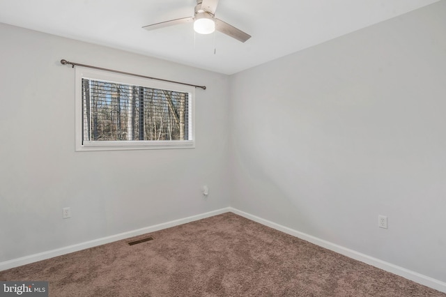 carpeted spare room with ceiling fan