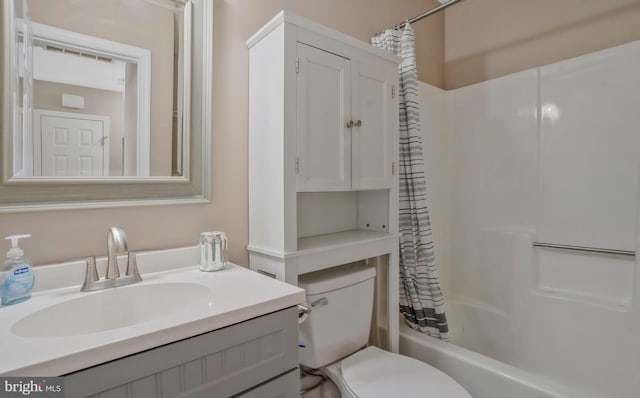 full bathroom featuring vanity, toilet, and shower / tub combo with curtain