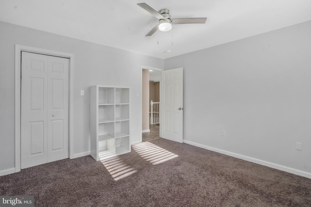 unfurnished bedroom featuring carpet floors, a closet, and ceiling fan