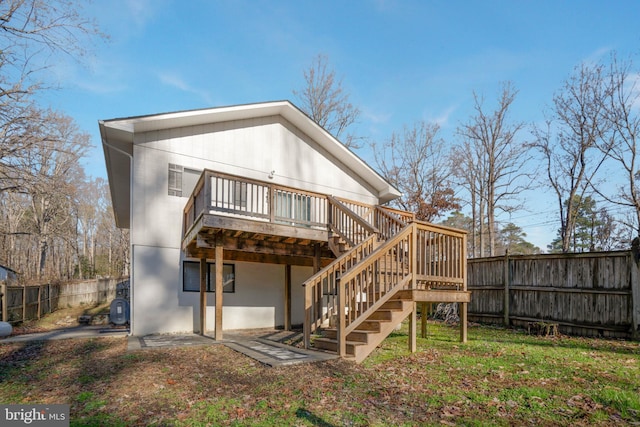 back of house featuring a deck