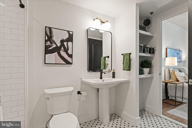 full bathroom with baseboards and toilet