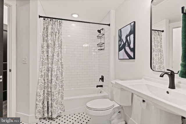 full bath featuring a sink, tile patterned floors, shower / bath combination with curtain, and toilet