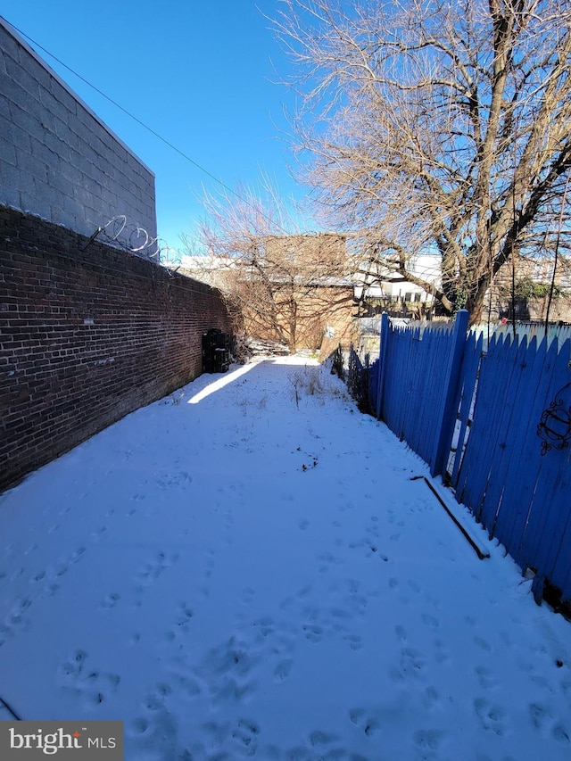 view of yard layered in snow