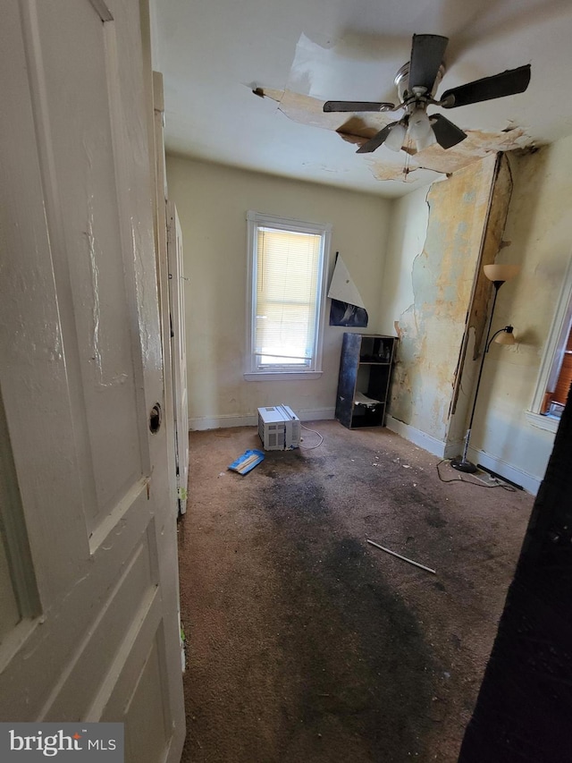 misc room featuring carpet flooring and ceiling fan