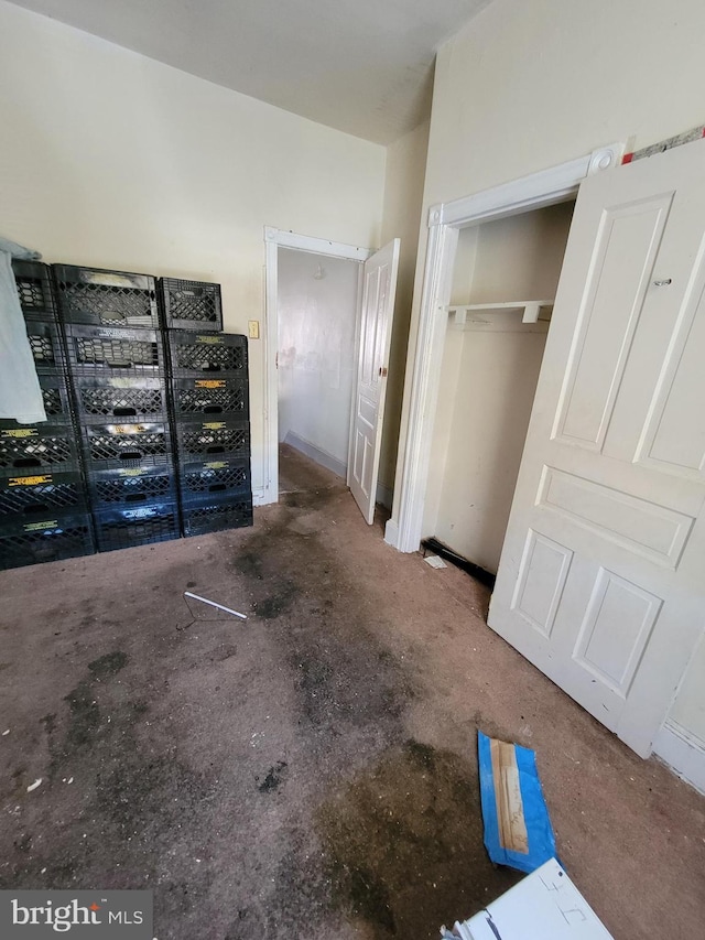 unfurnished bedroom featuring concrete flooring