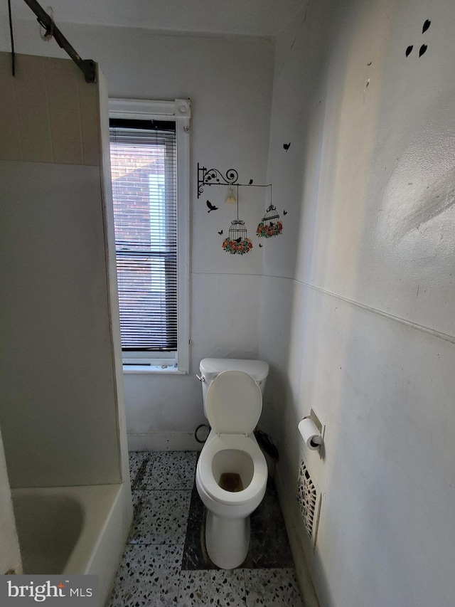 bathroom featuring toilet and shower with separate bathtub