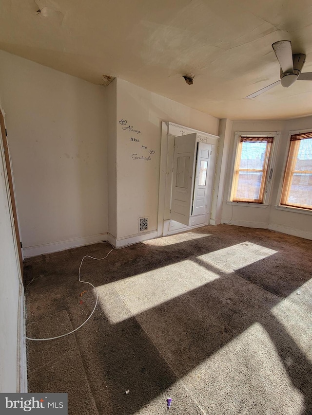 carpeted entryway with ceiling fan