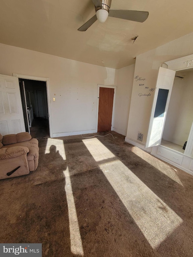 unfurnished living room with ceiling fan and carpet floors