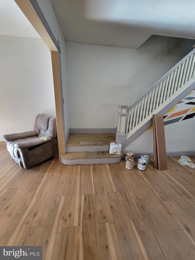 stairs with wood-type flooring and a barn door