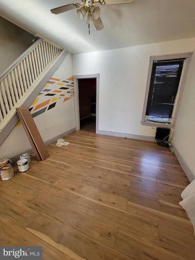 interior space with hardwood / wood-style floors and ceiling fan